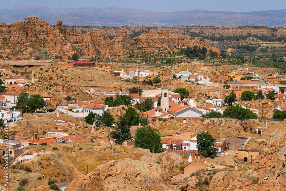 Aerial view of the Barrio de Cuevas in Guadix, a neighborhood with troglodyte cave-houses in Andalucia, in the south of Spain - Homes dug out of the hills located north of the Sierra Nevada mountains