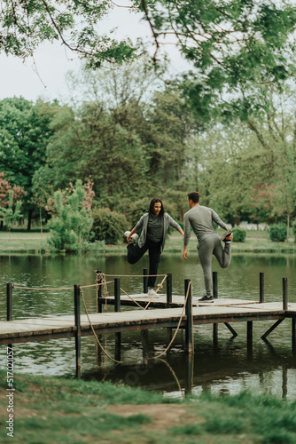 Couple on the bridge working out together