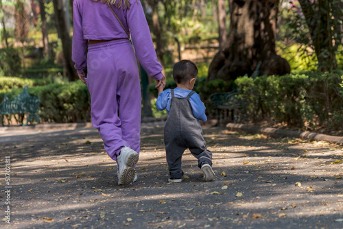 Latin mom with her baby boy having a walk at the park in Mexico City