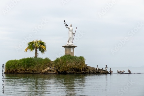 Statue of the god of the sea with pelicans on it in Livingston, Guatemala photo