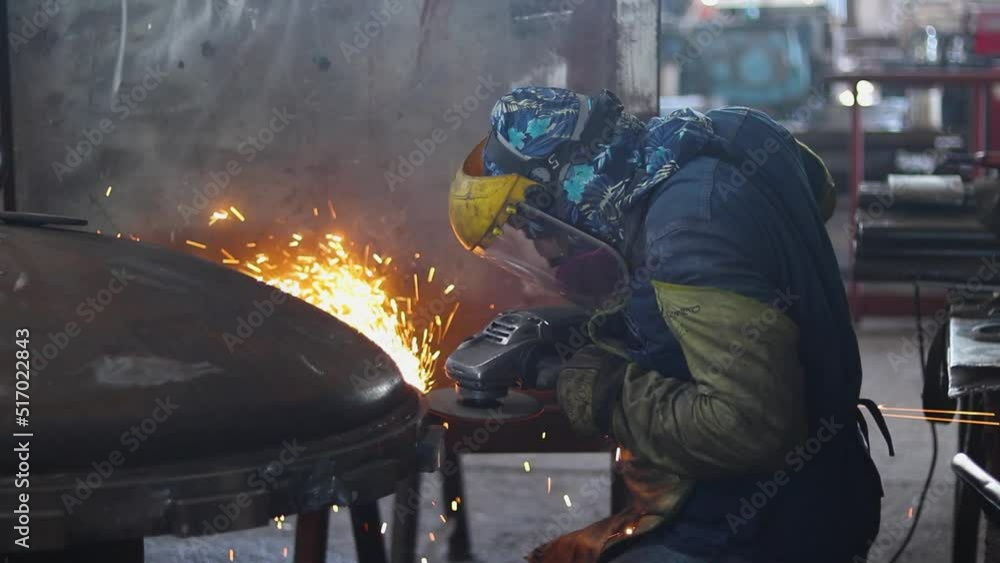 Worker polishing a boiler cover medium plane Worker polishing a boiler cover medium plane