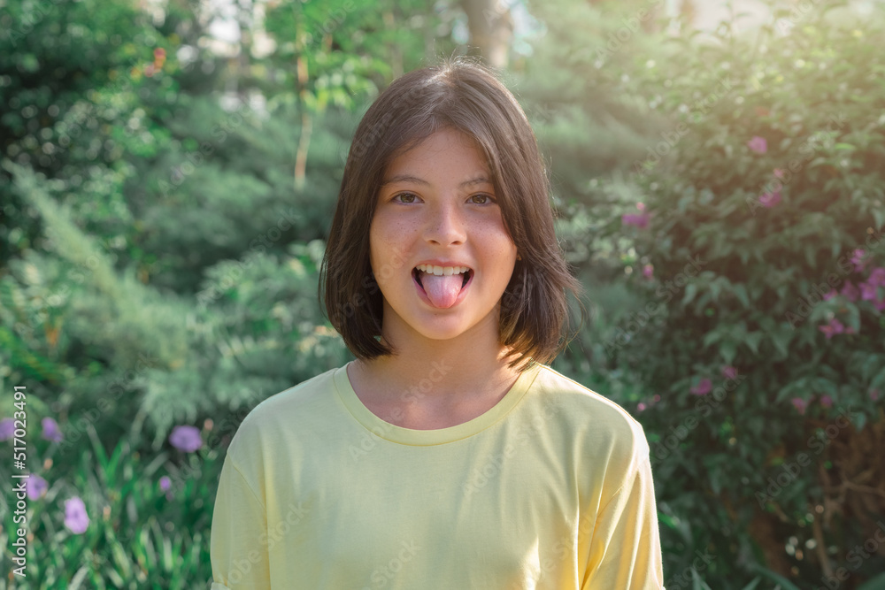 Portrait of a cheerful playful young girl who shows her tongue. Portrait of a cheerful playful young girl who shows her tongue.