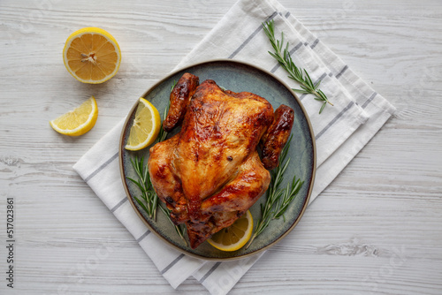Homemade Lemon and Herb Rotisserie Chicken on a Plate, top view. Flat lay, overhead, from above.
