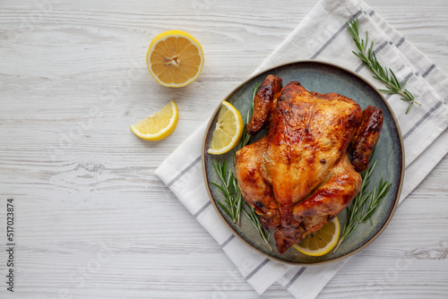 Bild auf Leinwand Homemade Lemon and Herb Rotisserie Chicken on a Plate, top view