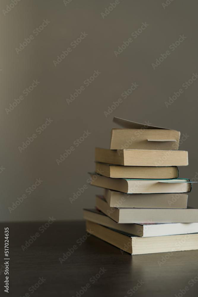 Pile of books ready to be read or that have been read on Book Day on top of a wooden table Pile of books ready to be read or that have been read on Book Day on top of a wooden table