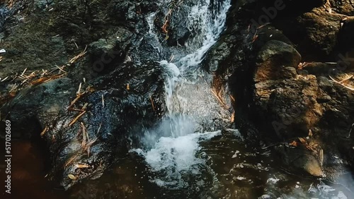 water flowing over rocks , dramatic water fall in the river suitable for cinematic and romantic vibes