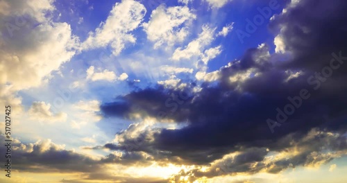 sun rays break through dark storm clouds