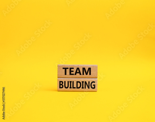 Team Building symbol. Concept word Team Building on wooden blocks. Beautiful yellow background. Business and Team Building concept. Copy space