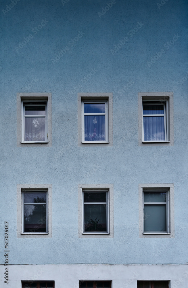 Minimalist house facade with windows and a blue color gradient