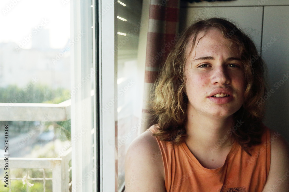 Portrait of a real teenager with long hair at home Portrait of a real teenager with long hair at home