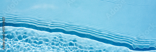 Background, texture of transparent blue water with seething ripples , waves