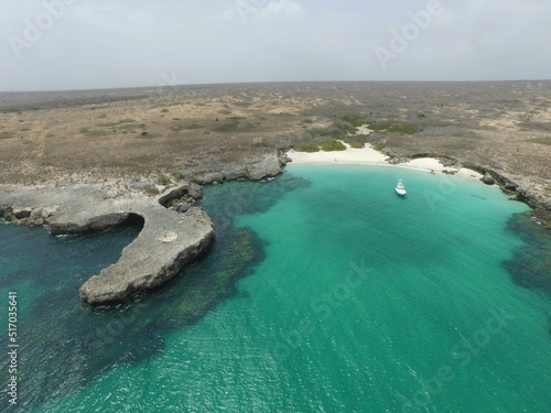 Aerial shot of Island Blanquilla in Venezuela with clear water and a boat photo