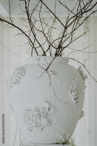 Vertical view of the dry branches in a white vase photo