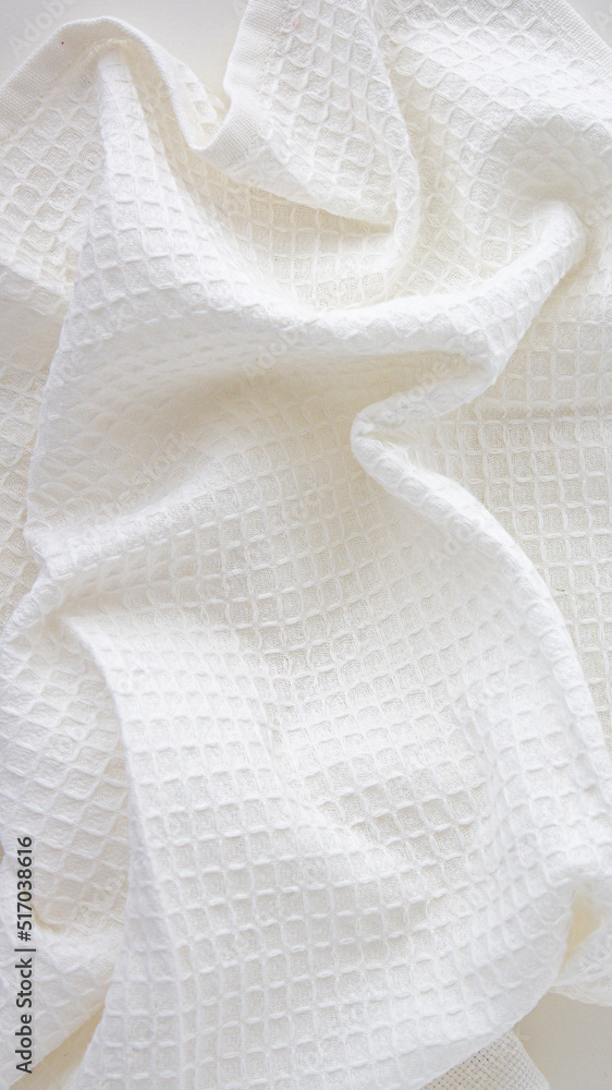 white kitchen towel with texture on a light background white kitchen towel with texture on a light background