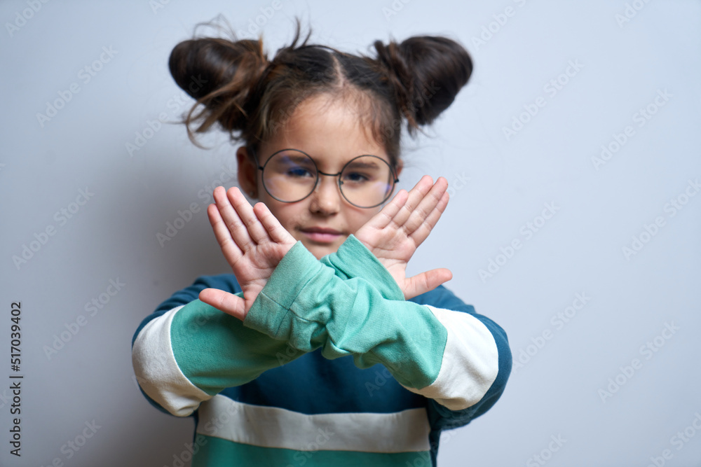 Say no to child abuse. Little girl showing stop gesture isolated on white background - obrazy, fototapety, plakaty 