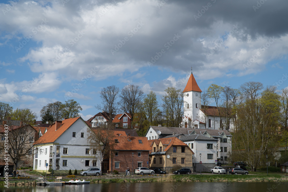 Talsi, Latvia - 6 May 2022: Talsi Old Town, the town promenade and the church in spring with sky and clouds.