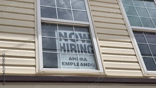 Help Wanted, Ahora Empleando, sign in English and Spanish hanging in a store window in rural West Virginia. photo