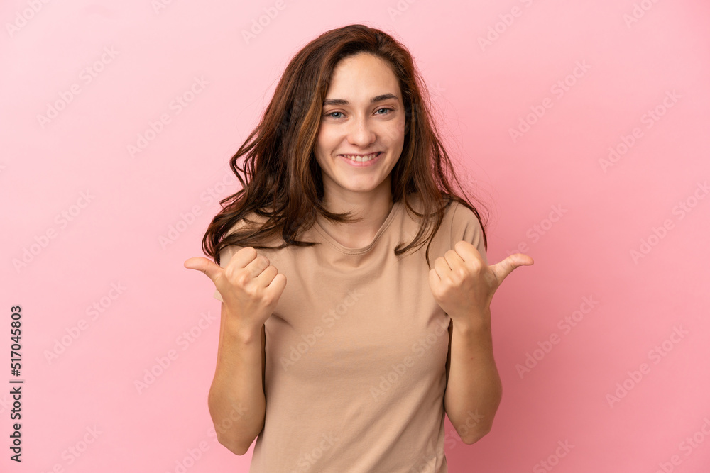 Young caucasian woman isolated on pink background with thumbs up gesture and smiling Young caucasian woman isolated on pink background with thumbs up gesture and smiling