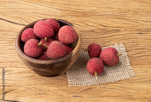 Lychees in a bowl over wooden table