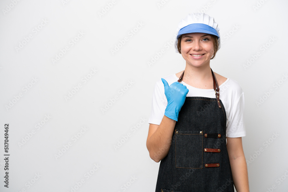 Fishmonger woman wearing an apron pointing to the side to present a product Fishmonger woman wearing an apron pointing to the side to present a product