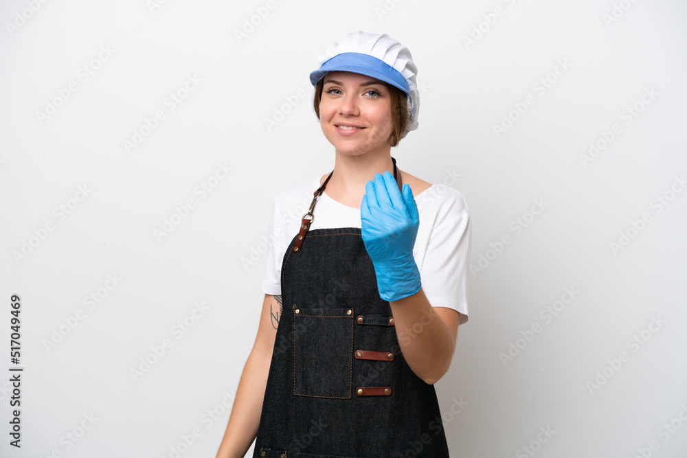 Fishmonger woman wearing an apron inviting to come with hand. Happy that you came Fishmonger woman wearing an apron inviting to come with hand. Happy that you came