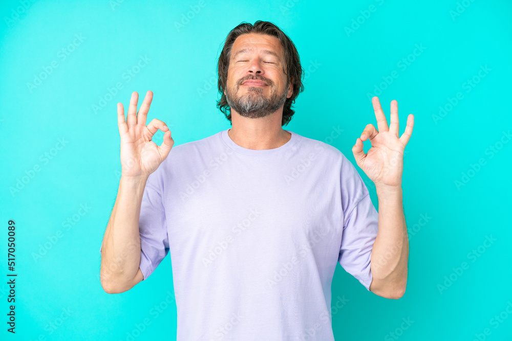Senior dutch man isolated on blue background in zen pose Senior dutch man isolated on blue background in zen pose