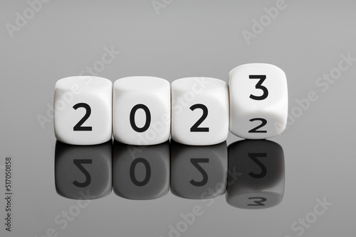 Flipping of white cube block for change 2022 to 2023. New year is coming concept