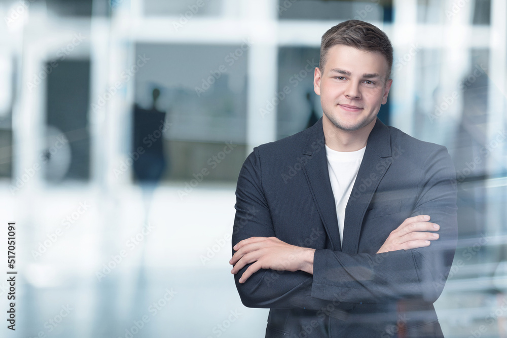 Businessman stands with his arms crossed on a blurred background. Businessman stands with his arms crossed on a blurred background.