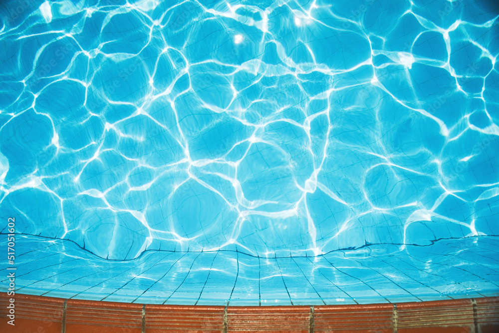 Obraz premium Water background, surface of the pool in ripples and sun glare. Nature background, vacation concept
