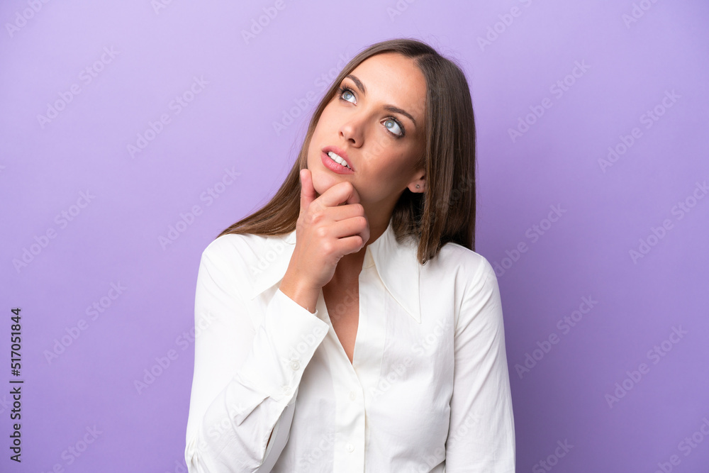 Young caucasian woman isolated on purple background having doubts Young caucasian woman isolated on purple background having doubts
