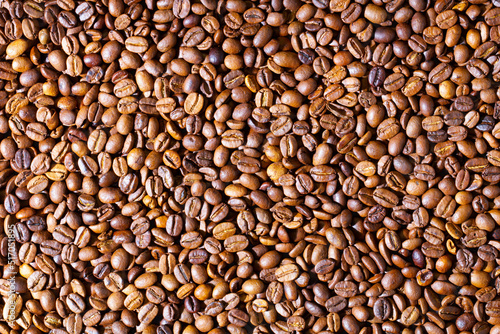 Coffee beans. Background of roasted fresh brown coffee beans. Perfect for a cool wallpaper. Banner for cafe. Template for cafe menu. Copy space. Beautiful closeup shot of fresh black coffee beans