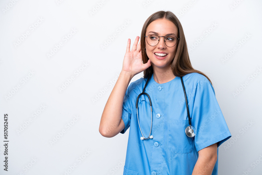 Young nurse caucasian woman isolated on white background listening to something by putting hand on the ear Young nurse caucasian woman isolated on white background listening to something by putting hand on the ear