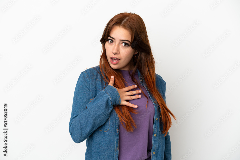 Young redhead woman isolated on white background surprised and shocked while looking right Young redhead woman isolated on white background surprised and shocked while looking right