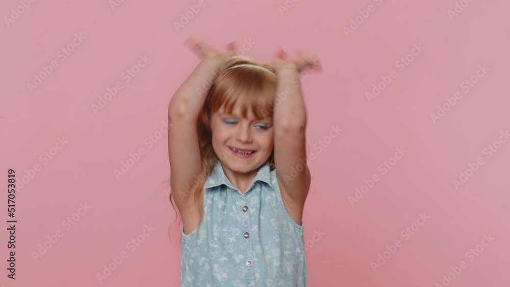 I am little bunny rabbit. Lovely funny young preteen child girl kid smiling friendly and doing bunny ears gesture on head, having fun, fooling with humorous comical mood. Little cute toddler children I am little bunny rabbit. Lovely funny young preteen child girl kid smiling friendly and doing bunny ears gesture on head, having fun, fooling with humorous comical mood. Little cute toddler children