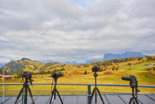 Several cameras are on tripods. Shooting a mountain landscape in the Dolomites, Italy