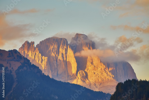 sunset over the Catinaccio group seen by Pozza di Fassa inside the Dolomite mountain range