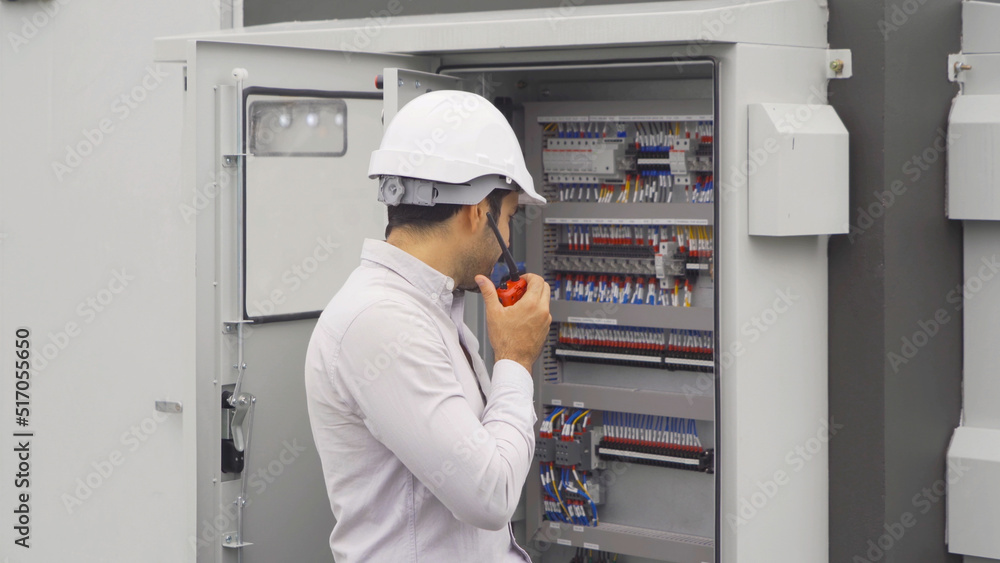 An engineer man or worker, people working in electrical room. Power energy motor machinery cabinets with panel in control or server room, operator station network in industry factory. Switchgear An engineer man or worker, people working in electrical room. Power energy motor machinery cabinets with panel in control or server room, operator station network in industry factory. Switchgear