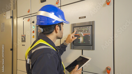 An engineer man or worker, people working in electrical room. Power energy motor machinery cabinets with panel in control or server room, operator station network in industry factory. Switchgear
