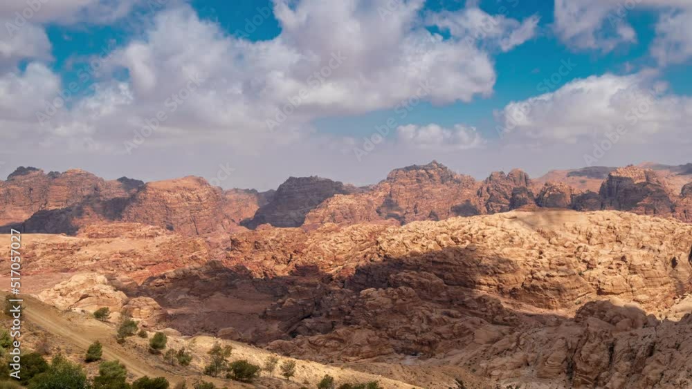 Timelapse clouds over Rocky sandstone mountains landscape in Jordan desert near Petra ancient town, Jordan. Beautiful scenery of Jordan desert. Timelapse clouds over Rocky sandstone mountains landscape in Jordan desert near Petra ancient town, Jordan. Beautiful scenery of Jordan desert.
