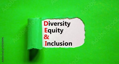DEI Diversity equity and inclusion symbol. Concept words DEI diversity equity and inclusion on the white paper on beautiful green background. Business DEI diversity equity and inclusion concept.