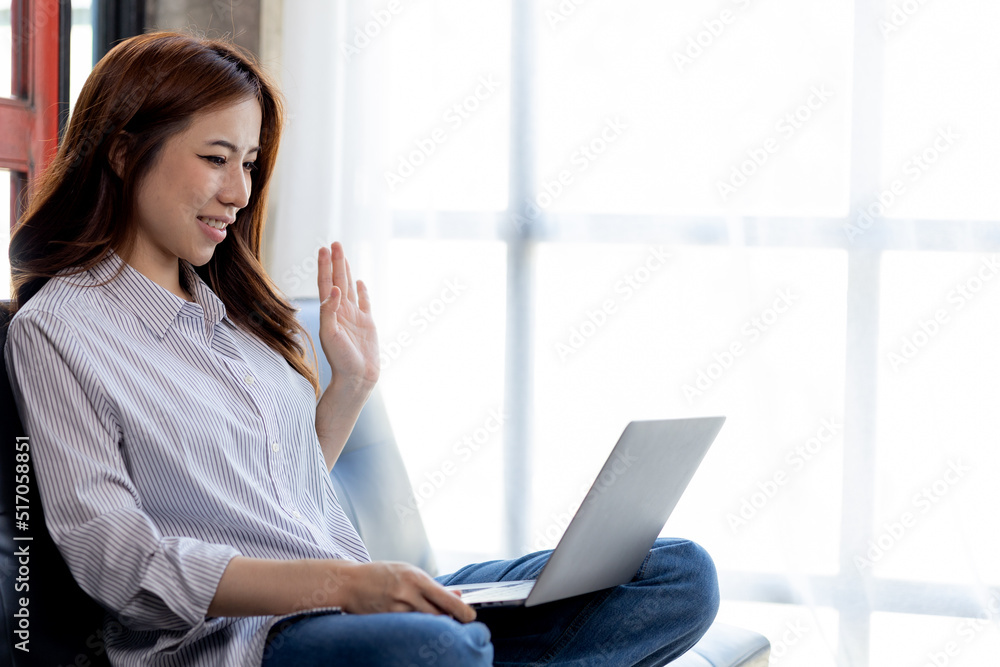 Asian businesswoman looking at laptop screen and remote video call with startup partner, she talks to her friend through program on laptop. Concept of using communication technology. Asian businesswoman looking at laptop screen and remote video call with startup partner, she talks to her friend through program on laptop. Concept of using communication technology.