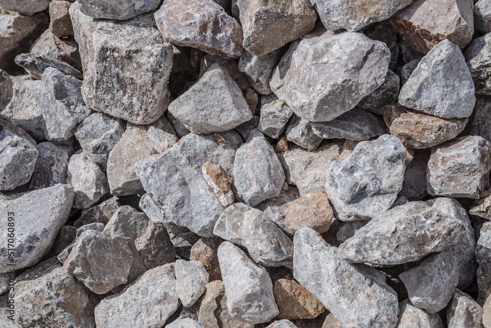 Stones cobblestones under the railway.Lime stone close-up as a background Stones cobblestones under the railway.Lime stone close-up as a background