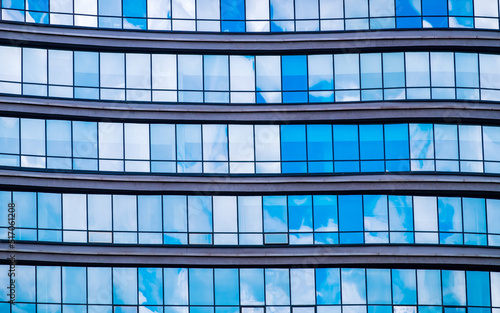 Reflection of sky in glass facade of office building