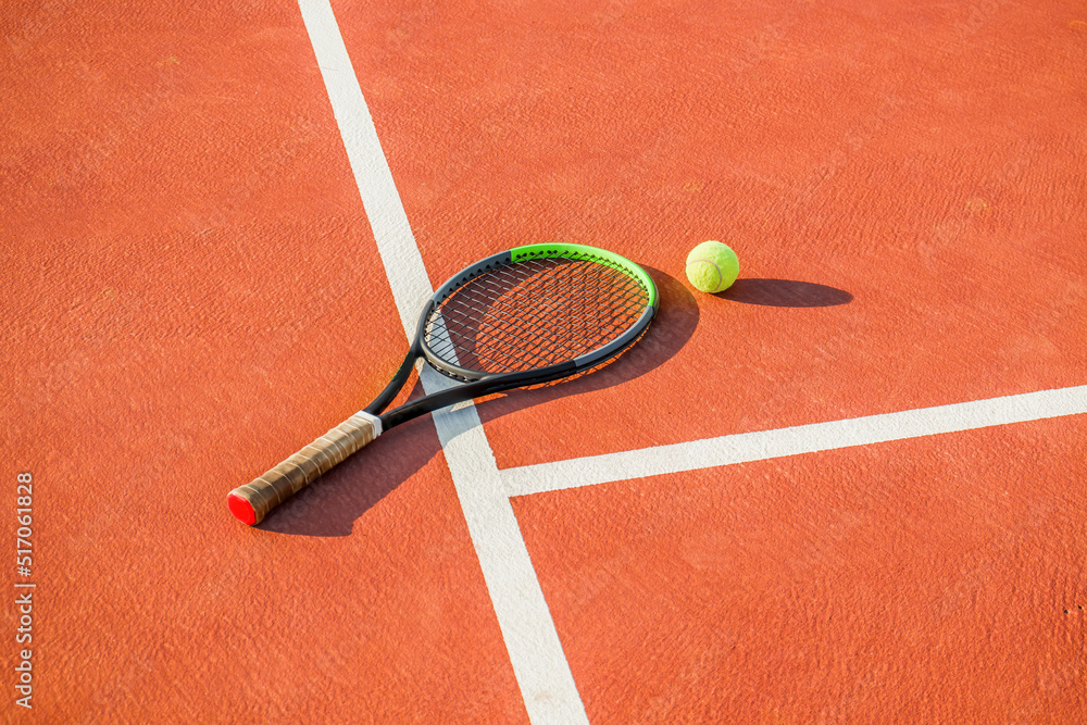 Tennis racket and ball on the court. Hard cover.