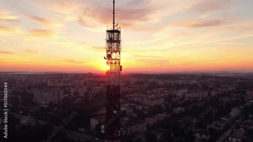 Television or radio telephone tower in a cityscape at sunset