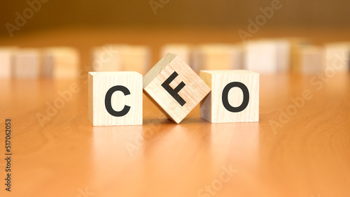 CFO text on wooden blocks, financial business concept, brown background