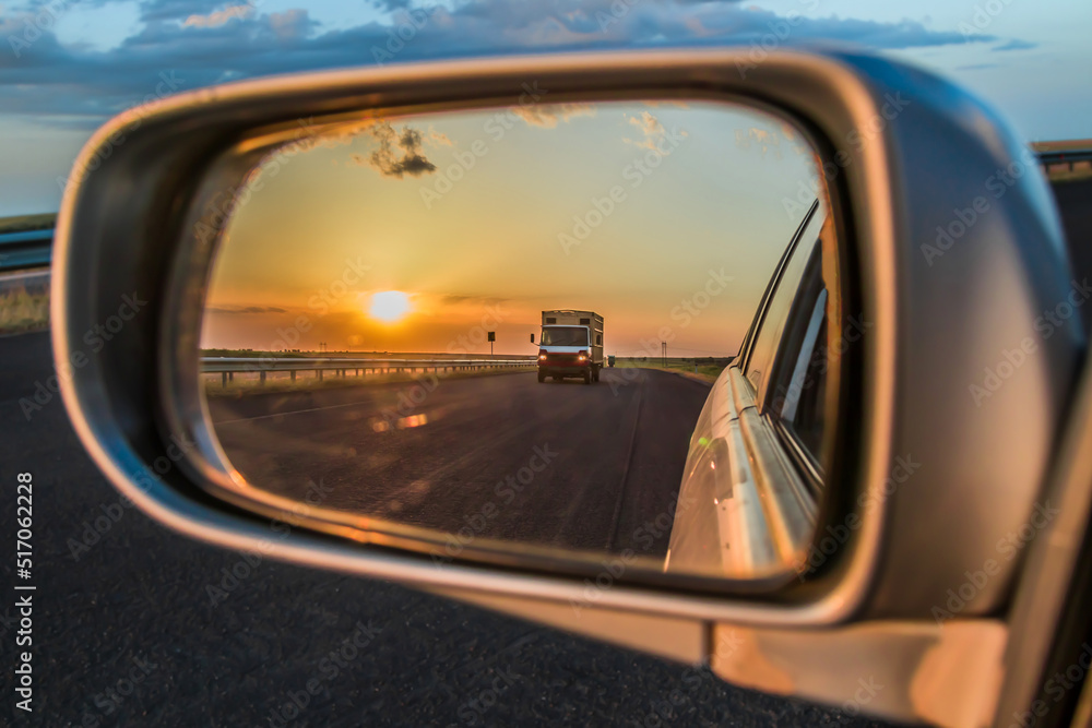Car mirror with beautiful sunset view