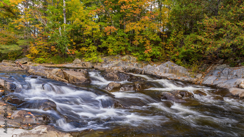 Sandy River - A closeup view of rocky Sandy River on a colorful Autumn morning at Madrid, Maine, USA.