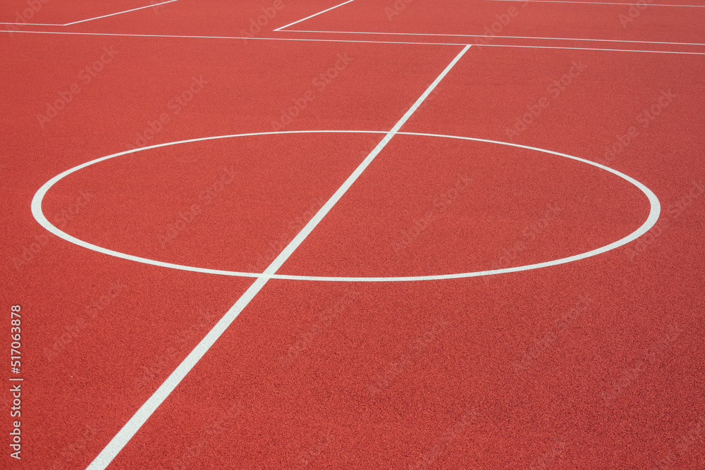 Sports court background. Top view to red artificial rubber ground with central circle field line with copy space