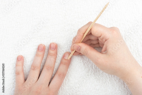 Pushing the cuticle with an orange stick to the base of your nail.